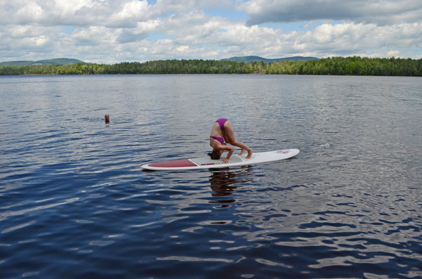 stand up paddleboarding headstand 1